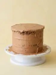 Three freshly baked layers of Triple Chocolate Zucchini Cake cooling on wire racks