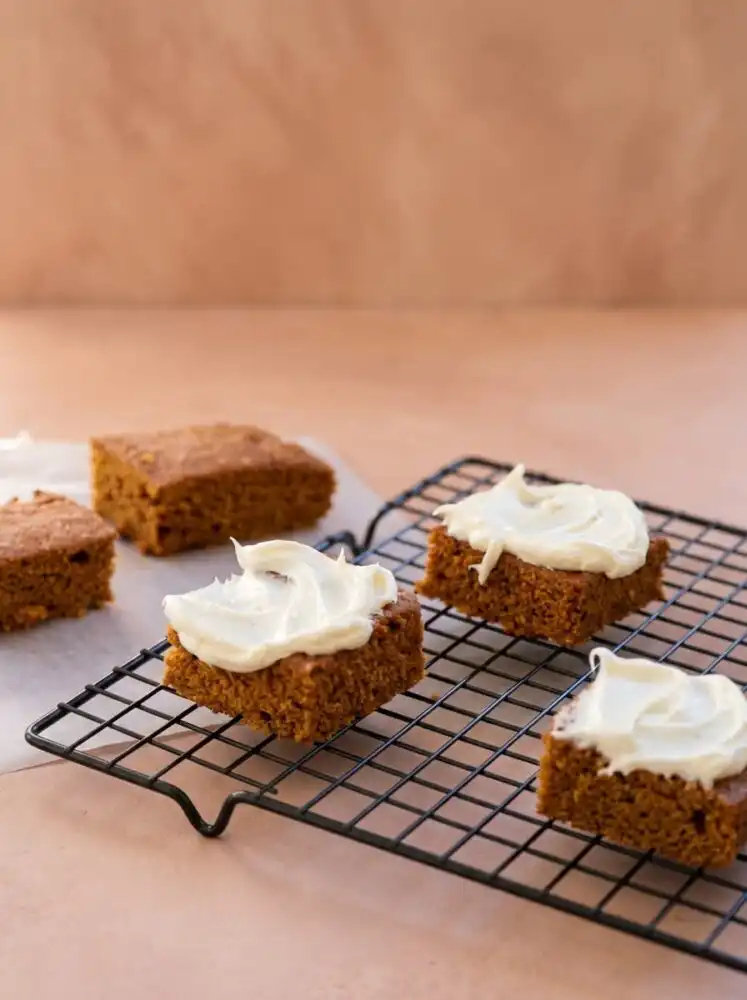 Home - Cake Savor - Savor the Simple 6 A warm golden brown Two Ingredient Pumpkin Spice Cake cooling in a baking pan on a wire rack.