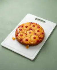 A golden brown Cast Iron Skillet Pineapple Upside Down Cake on a wire cooling rack.